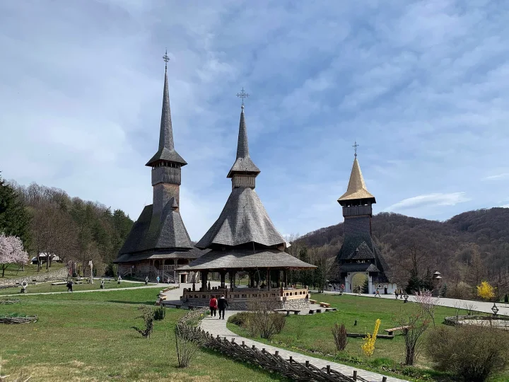 Maramures wooden church or monastery among green hills and traditional countryside